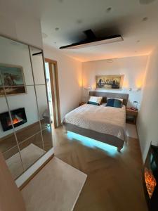 a bedroom with a bed and a glass wall at ViSky Ap in Visaginas
