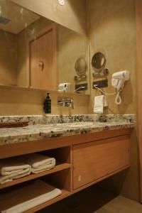 a bathroom with a sink and a large mirror at Hotel Tavijay in Jhunjhunūn +54 photos