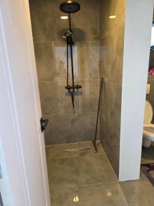 a shower in a bathroom with a toilet at Villa Violand in Limanu +10 photos