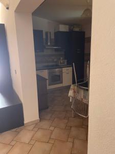 a view of a kitchen with a stove and a floor at Casa Camere Pistis in Assemini +20 photos