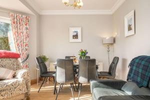 a living room with a dining room table and chairs at Turner's Corner by Escape Ordinary in Aghadowey