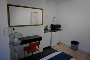 a bathroom with a sink and a desk with a mirror at Blouberg Beach Retreat in Bloubergstrand +19 photos