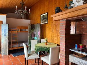 a dining room with a table and a bunk bed at Casa do Adro in Viana do Castelo