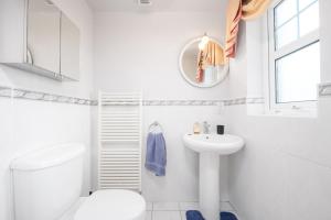 a white bathroom with a sink and a toilet at Turner's Corner by Escape Ordinary in Aghadowey +45 photos
