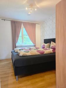 a bedroom with a large bed with a window at Villa Älvskogen in Vidsel