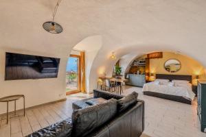 a living room with a bed and a couch at Casa Anastasia with private patio by GardaDoma in Brenzone sul Garda
