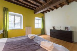 トリノにあるLa tua casa nel Quadrilateroのベッドルーム1室(大型ベッド1台、窓2つ付)