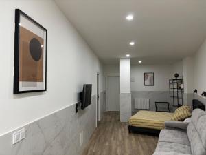 a living room with a couch and a bed at URDAIHOME SUITES & BIKEs in Guernica y Luno