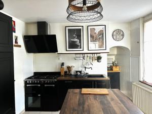 a kitchen with a sink and a stove top oven at Maison Familiale in Reugny +24 photos