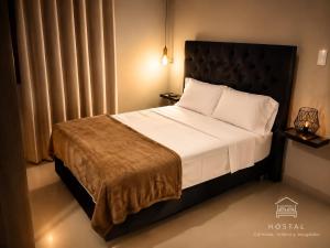 a bedroom with a large bed with white sheets and pillows at HOTEL SAN GABRIEL cerca AL CENTRO DE CHICLAYO in Chiclayo