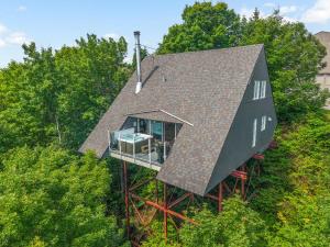 an overhead view of a house in the trees at The Perch - Spa & Pool in Beaupré