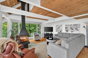a living room with a couch and a fireplace at The Perch - Spa & Pool in Beaupré
