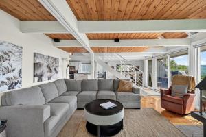 a living room with a couch and a table at The Perch - Spa & Pool in Beaupré +51 photos