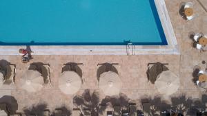 an overhead view of a swimming pool with umbrellas at Angela Suites Boutique Hotel in Sisi
