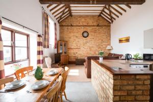 a kitchen and living room with a table and chairs at Cottage 2 at Scald end cottages in Bedford
