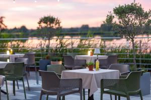 a row of tables and chairs on a patio at Hotel Duo Spa in Janów Lubelski