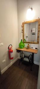 a room with a table with a mirror and a fire extinguisher at Belle Époque in Taranto +70 photos