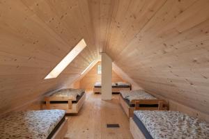 a room with three beds in a wooden room at Ochsenwaldhütte in Teschrepl