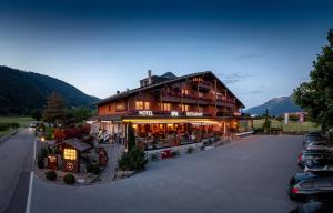 a large building with cars parked in a parking lot at SALZANO Hotel - Spa - Restaurant in Interlaken