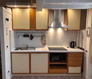 a kitchen with a sink and a stove at Maison Lume in Ponte di Legno