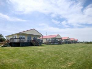 a row of houses in a field of grass at Montgomery Cavendish Cottages in New Glasgow