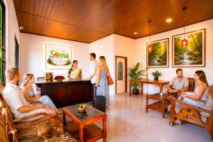 a group of people sitting in a room at Soma Seven Springs Resort in Munnar +76 photos