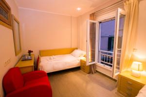 a small bedroom with a bed and a window at The Golden Nest Corfu in Corfu +7 photos