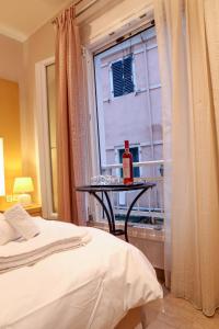 a room with a bed and a table with a bottle on it at The Golden Nest Corfu in Corfu