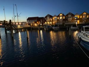 a marina at night with houses and boats in the water at SeaviewHouse Rudkøbing in Rudkøbing