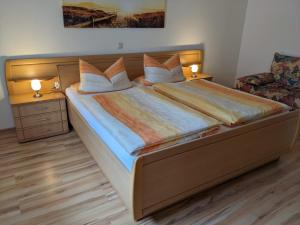 a bedroom with a large bed with two night stands at Appartement Karolina in Bad Soden-Salmünster
