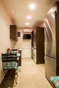 a kitchen with a stainless steel refrigerator and appliances at The Golden Nest Corfu in Corfu