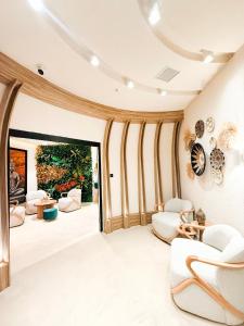 a living room with white chairs and a large window at Cityloft 175 in Istanbul