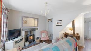 a living room with a couch and a fireplace at 1 Bed in Hawkshead oc-lr067 in Hawkshead