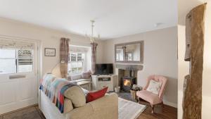a living room with a couch and a fireplace at 1 Bed in Hawkshead oc-lr067 in Hawkshead +6 photos