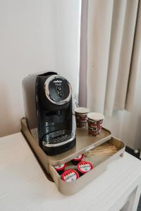 a toaster oven sitting on top of a table at Alex&George Boutique Hotel in Cluj-Napoca