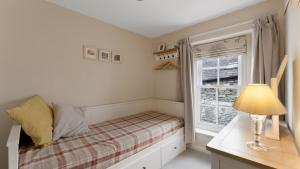 a small bedroom with a bed and a window at 1 Bed in Hawkshead oc-lr067 in Hawkshead