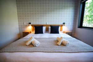 a bedroom with a bed with two towels on it at STARRY The Garden Hakuba Iwatake in Hakuba