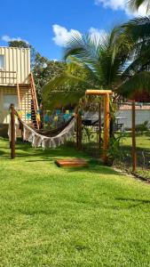 a playground with a slide in a yard at Villa Davi, A 100m DA PRAIA! in Barra Grande