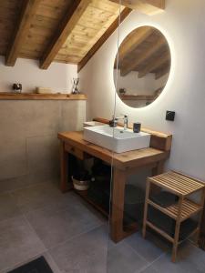 a bathroom with a sink and a mirror at Le BÔ Chalet - Jacuzzi et Sauna - 3 chambres in Anould +63 photos