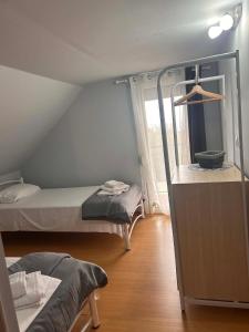 a room with two beds and a window at Άνεμος Home 2 in Kavála