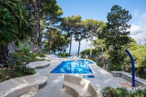 a swimming pool in a resort with trees at Villa Lia Hotel Capri in Capri