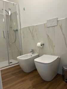 a white bathroom with a toilet and a shower at Da Noi Panoramic Guest Stay Camera Orizzonte in Cuorgnè