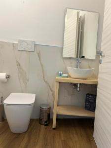 a bathroom with a sink and a toilet and a mirror at Da Noi Panoramic Guest Stay Camera Orizzonte in Cuorgnè