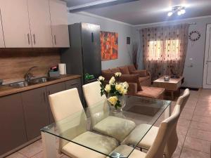 a kitchen and a living room with a glass table at Άνεμος Home 2 in Kavála +24 photos