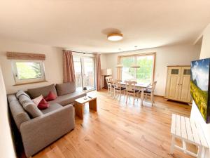 a living room with a couch and a table at VILLAWILLI - Gemütliche Ferienwohnungen in Fischen +116 photos