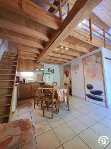 a kitchen and dining room with a table and chairs at Moulin de Record in Ferrières