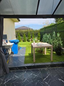 a patio with a table in a yard at Villa Violand 2 in Limanu