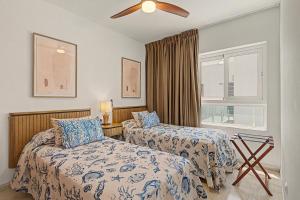 a bedroom with two beds and a ceiling fan at Callao Beach 6 in Arrieta +18 photos