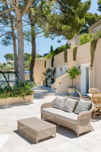 a patio with a couch and tables and trees at Villa Lia Hotel Capri in Capri