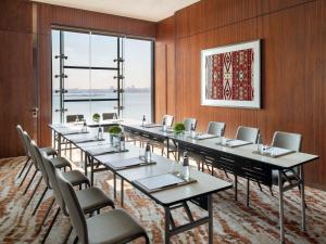 a conference room with a long table and chairs at Swissôtel Corniche Park Towers Doha in Doha +123 photos